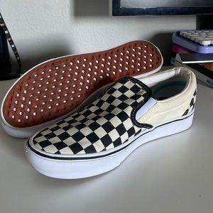 Vans checkered slide ons.